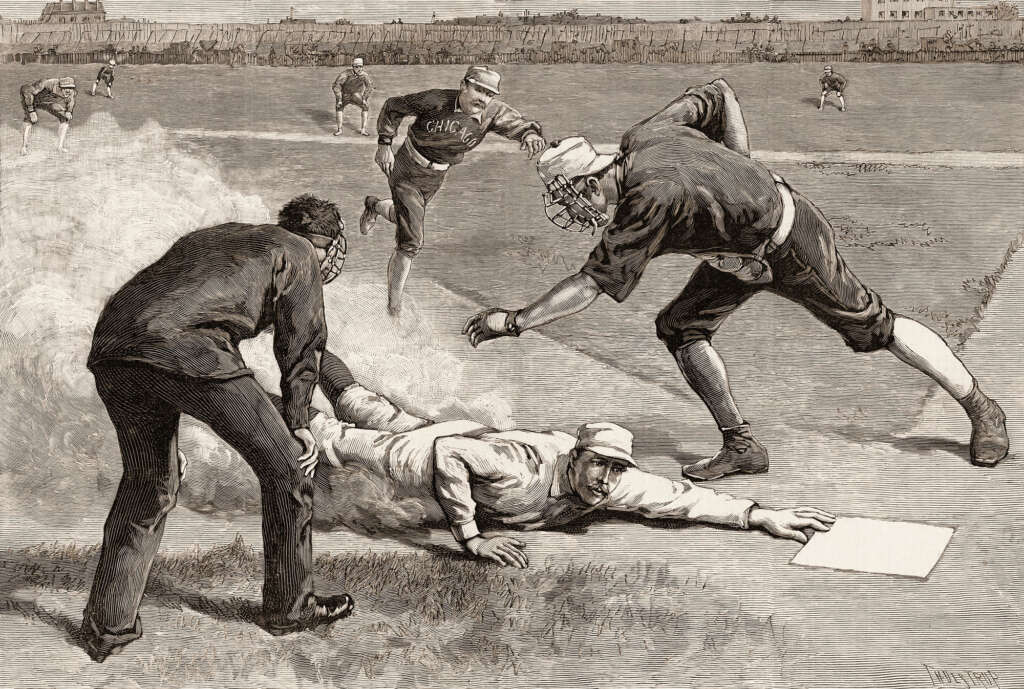 A vintage illustration of a baseball game shows a player sliding into a base while two opposing players, one with a ball and the other observing, try to tag him out. Other players and the field are visible in the background.