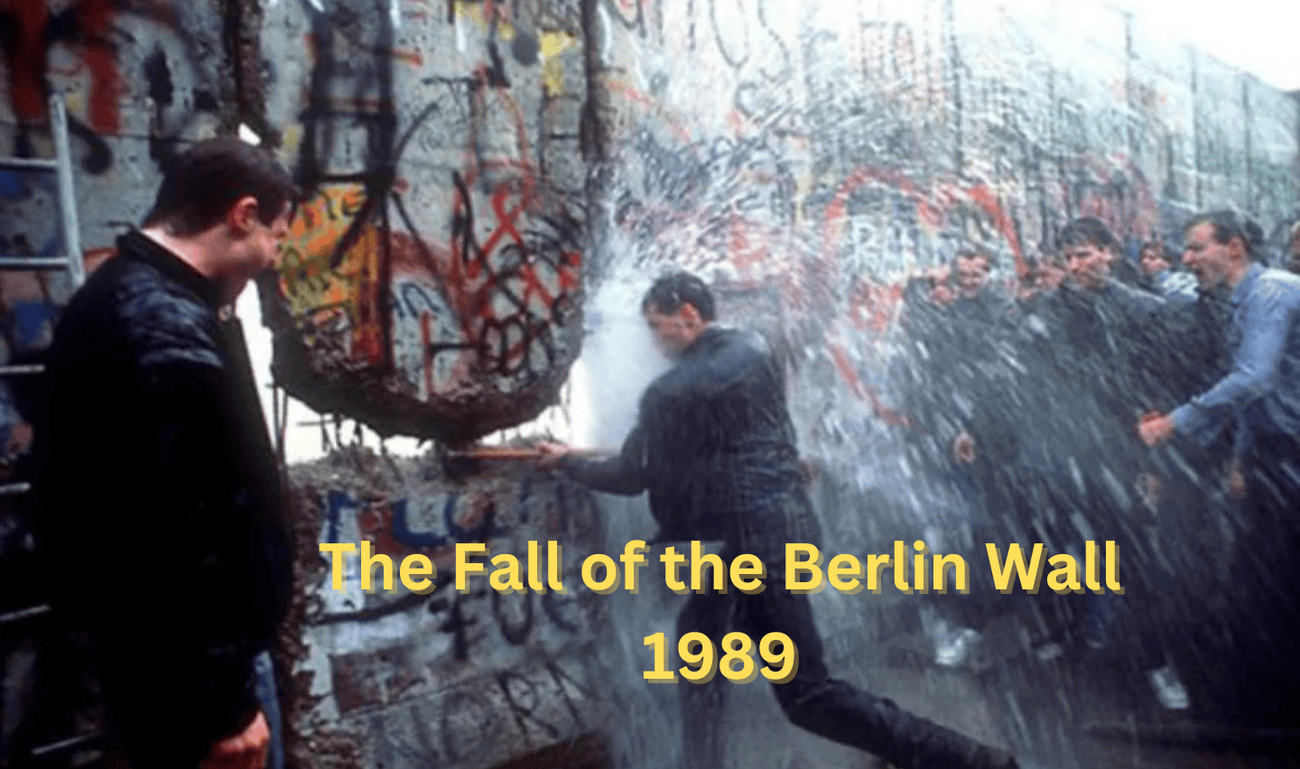 A group of people breaking through the Berlin Wall with a sledgehammer, surrounded by spray and graffiti. The text reads, "The Fall of the Berlin Wall 1989.