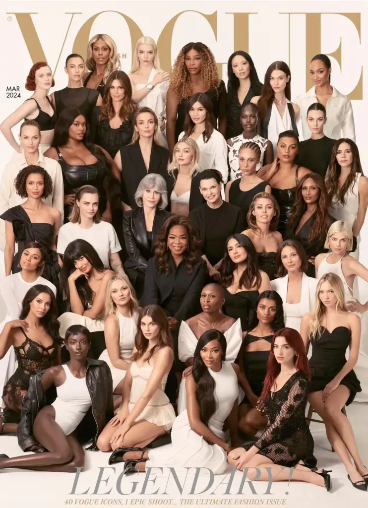 A diverse group of women, dressed in a variety of elegant black and white outfits, pose together for Vogue's March 2024 cover titled "Legendary." The image captures 40 models of varying styles and backgrounds, highlighting fashion diversity.