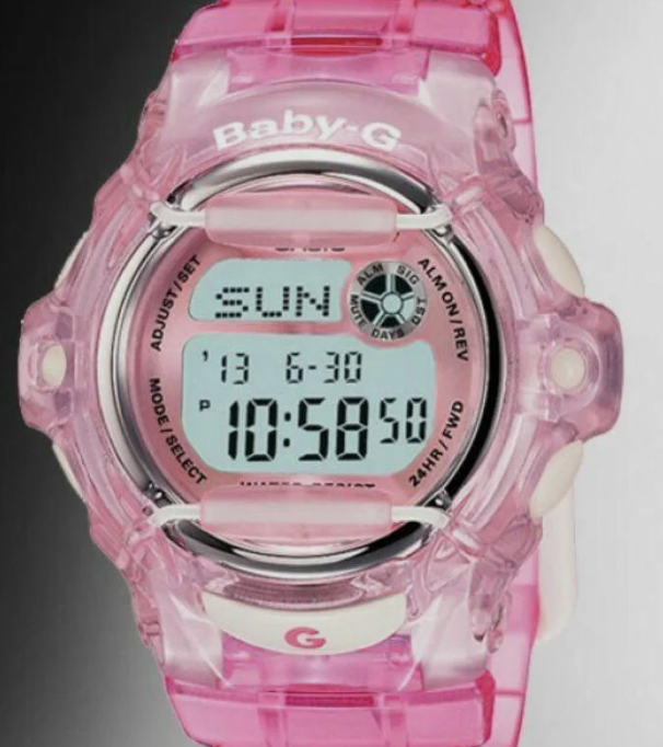 A pink Baby-G digital wristwatch displaying the time 10:58:50 and the date as Sunday, 13th. The watch has various buttons for functions like adjust, mode select, and 24hr light.