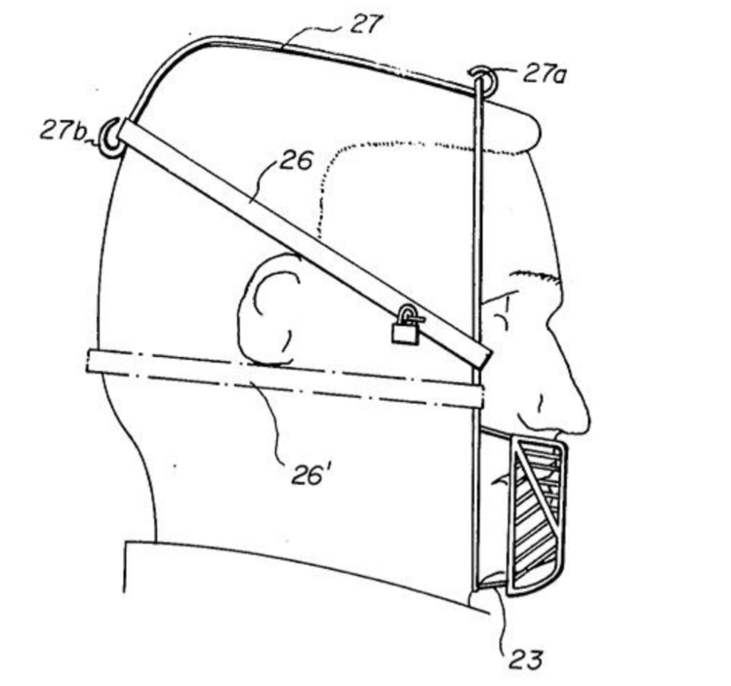 Illustration of a side view of a person wearing a headgear with a cage-like covering over the mouth and a strap around the head. The cage is attached to a band that encircles the head, with a lock depicted on the side.